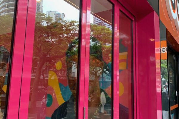 Exterior transformation with wall panels, pink wrap, and illuminated letters by Artline Signs, Gold Coast