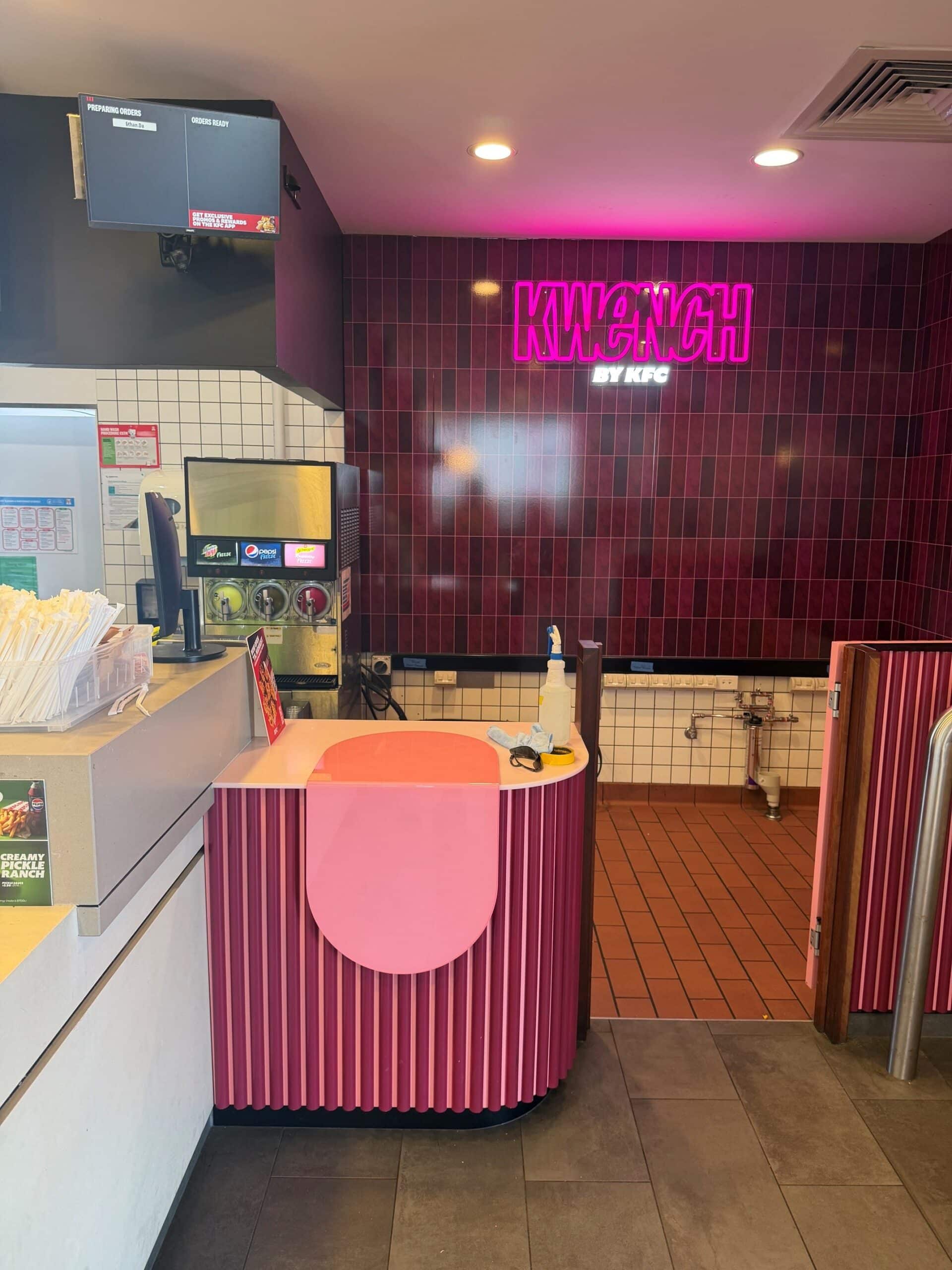Illuminated pink KWENCH by KFC wall sign above the counter at Caloundra, manufactured and installed by Artline Signs.